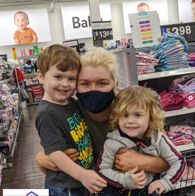 Giving Event - Family Holding Gift Card Smiling
