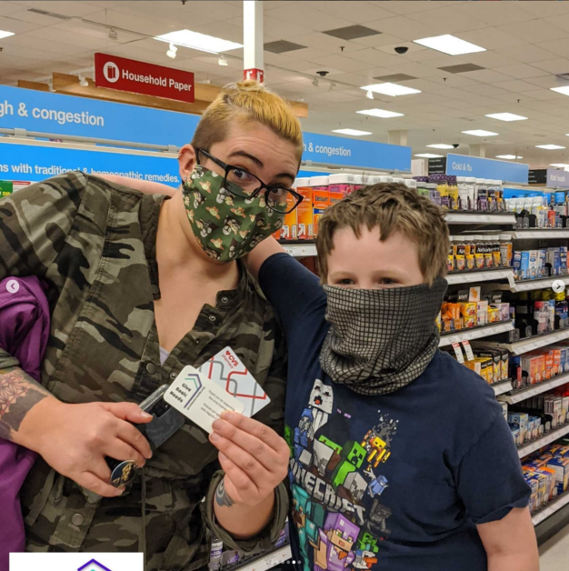 Giving Event - Person and Child Holding Gift Card Smiling