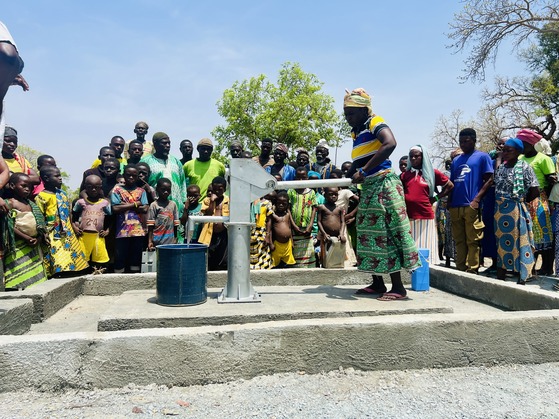 residents using a borehole installed by give basic needs